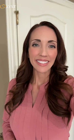 Smiling real estate agent in a pink blouse.