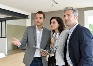 Realtor showing a couple a house, considering buying property.
