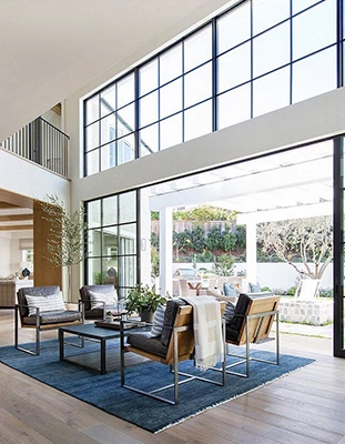 Bright modern living room with large windows, part of an Property Tour.
