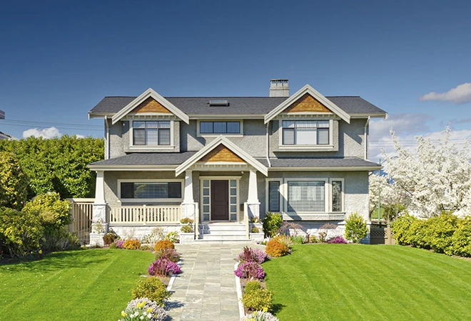 Well-maintained house with a green lawn, ideal for rental property.