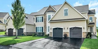Suburban homes with driveways and garages, relevant to property buying.