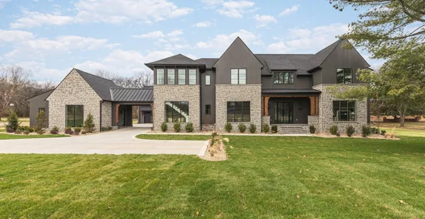 Modern luxury real estate home with stone and dark siding
