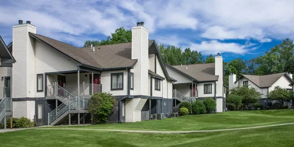 Apartment buildings with manicured lawns, showcasing real estate